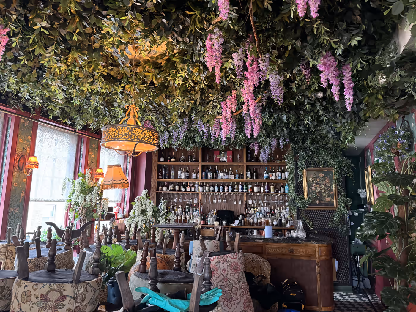 Dense artificial foliage installed across a restaurant ceiling
