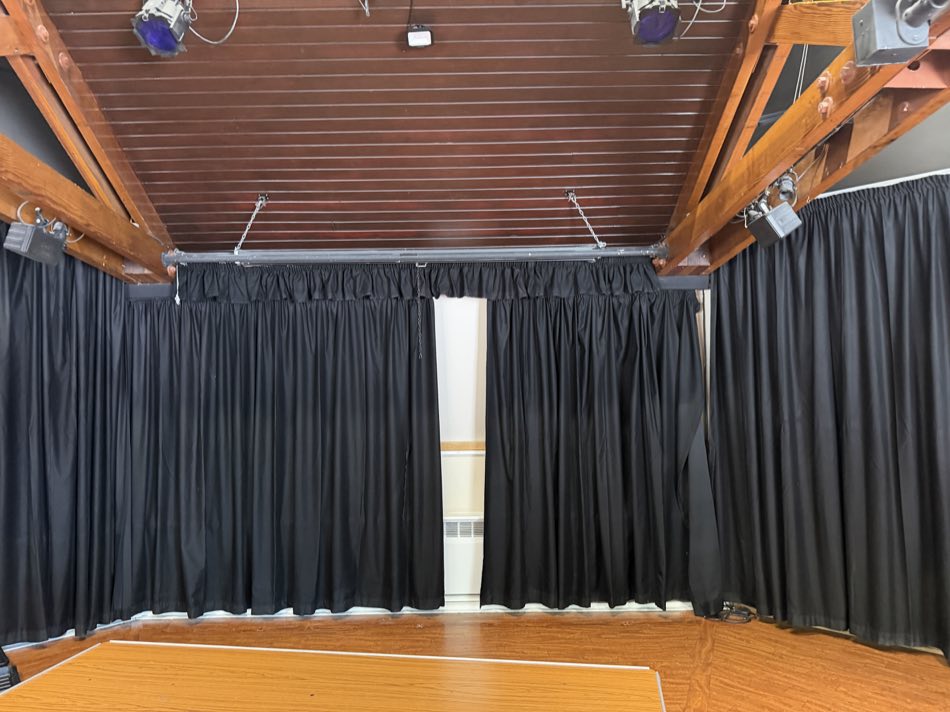 Black curtains around a playhouse stage